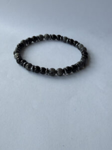 Gray and Black Beaded Stretch Bracelet for Men with Metallic-Color Spacers — lifestyle photo