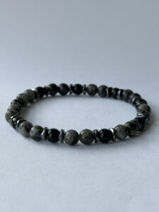 Gray and Black Beaded Stretch Bracelet for Men with Metallic-Color Spacers — lifestyle photo