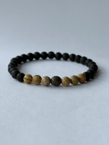 Black and Brown Beaded Stretch Bracelet for Men with Carved Bronze-Color Accent — lifestyle photo