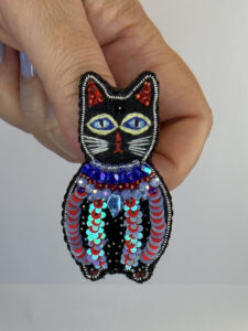 Black Cat Brooch with Sequin Coat – Hand-Embroidered Face and Beaded Pin — lifestyle photo