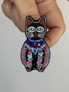 Sequin Black Cat Brooch with Blue Bead Collar – Hand-Embroidered Pin — lifestyle photo